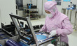 Workers produce automotive semiconductor products at a workshop of an automotive semicondu...