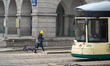 A walker with a dog is in the old town of Linz in Linz, Upper Austria, Austria, on Decembe...