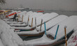 A boatman removes snow from a boat on the banks of Dal Lake after heavy snowfall in Srinag...