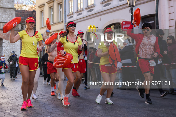 People dressed in funny costumes attend the traditional 20th Krakow New Year's Run in the Old Town on the New Year's Eve in Krakow, Poland o...