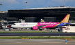 An Airbus A321-271NX from Wizz Air (Team Hungary Livery) is parked, waiting for passengers...