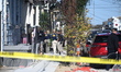 Police, ATF, and FBI agents are outside a house where a fire occurs on Mandeville Street,...