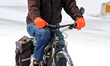 A cyclist rides his bike on a snow-covered street in downtown Brampton, Ontario, on Januar...