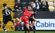 Aaron Drinan of Swindon Town competes with George Abbott and Rod McDonald of Notts County...