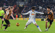 Leeds United's Ao Tanaka tries to keep the ball from Hull City's Matty Jacob and Hull City...