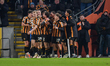 Hull City players celebrate Abu Kamara's second goal of the game, which makes the score 3-...