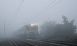 A local train moves through heavy fog on a cold winter morning in Kolkata, India, on Janua...