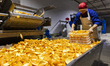 A worker processes navel oranges on the production line of an agricultural product product...