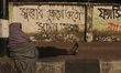 A rickshaw driver sleeps in his rickshaw on a street in Dhaka, Bangladesh, on January 9, 2...