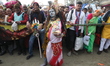 Hindu pilgrims arrive as a man dresses as Hindu Lord Shiva for alms from pilgrims at the c...