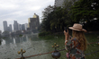 A tourist takes pictures of the polluted Bare Lake in Colombo, Sri Lanka, on January 15, 2...
