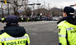Police monitor a rally outside the restricted-access Corruption Investigation Office for H...