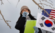 A supporter of impeached President Yoon Suk-yeol speaks in favor of him outside the restri...