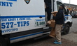 NYPD Police Crime Scene Unit investigators bring out evidence boxes and evidence bags at 1...