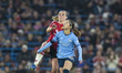 Yui Hasegawa #25 of Manchester City W.F.C. is challenged by Ella Toone #7 of Manchester Un...