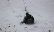 A child slides down a hill during a snowstorm in Houston, Texas, on January 21, 2025. 