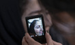 A female Iranian technician photographs a woman before she receives Botox injections at th...