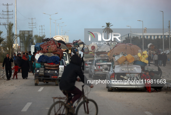 Palestinian displaced persons wait near a checkpoint on Salah al-Din Road in Nuseirat, on January 25, 2025, to return to their homes in the... by Majdi Fathi/NurPhoto
