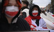 People carry a historical Belarusian flag and take part in the March of Belarusians in War...