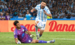 Adrian Martinez of Racing Club competes for the ball with the goalkeeper of Belgrano de Co...