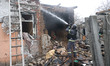 A firefighter puts out a fire in a house damaged by a Russian drone strike in Kharkiv, Ukr...