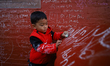A boy writes on the wall of Saraswati Temple, where the Hindu Goddess is worshipped annual...