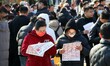 Job seekers learn about job openings at a large job fair in Jining, East China's Shandong...