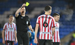 Tom Bradbury of Cheltenham Town receives a yellow card during the EFL Trophy Quarter Final...