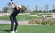 Haotong Li of China tees off during the third round of the Commercial Bank Qatar Masters g...