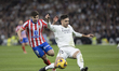 Raul Asencio of Real Madrid and Julian Alvarez of Atletico de Madrid fight for the ball du...