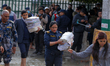 Officials retrieve court documents after flooding in the premises of Kathmandu District an...