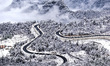 An aerial photo shows the scenery of a winding road after snow in Luojia Village, Yichang...