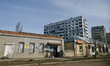 Men stand outside a shop in front-line Orikhiv, Polohy district, Zaporizhzhia region, sout...