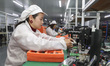 Workers produce electronic circuit boards at a workshop in Huai'an, China, on February 20,...