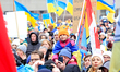 Participants gather to listen to speakers during a rally in support of Ukraine on the thir...