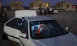 An Iranian man sits in his vehicle while visiting with his family at a tourist campsite in...