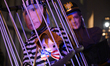 A puppet bears a mask depicting the president of Ukraine, Volodymyr Zelenskyy, that holds...