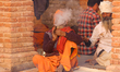 A Sadhu, or Hindu holy man, smokes marijuana on the premises of Pashupatinath Temple in Ka...