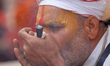 A Sadhu, or Hindu holy man, smokes marijuana on the premises of Pashupatinath Temple in Ka...