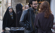 A veiled Iranian woman looks at another woman who is not wearing a mandatory headscarf in...