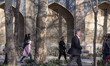 Iranian people walk along a pedestrian area outside the historical Chaharbagh seminary in...