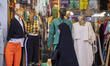 A veiled Iranian woman walks past a dress shop window outside the historical Chaharbagh se...