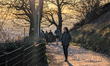 People walk on a warm winter evening in Freiburg im Breisgau, Baden-Wurttemberg, Germany,...