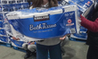 EDMONTON, CANADA - MARCH 2:A customer carries a 30-pack of toilet paper from a store shel...