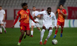 Enoch Biringanine Mushagalus of Valletta is followed by Paul Mbong of Birkirkara during th...
