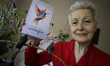 Catia Lattouf, a hummingbird rescuer, poses with her recent book ''Create your own miracle...