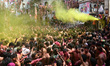 Revelers dance as they celebrate Holi, the spring festival of colors, in Prayagraj, India,...