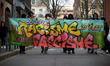 The banner reads 'Against state racism and fascism'. Nearly one thousand people take to th...