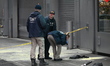 Members of the NYPD Crime Scene Unit investigate the scene and canvass the area while exam...