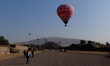 Balloons fly over the Pyramid of the Sun during the welcoming of the spring equinox at the...